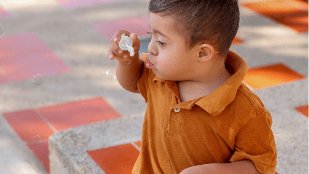a sen boy bloys bubbles as he enjoys sensory stories for special needs