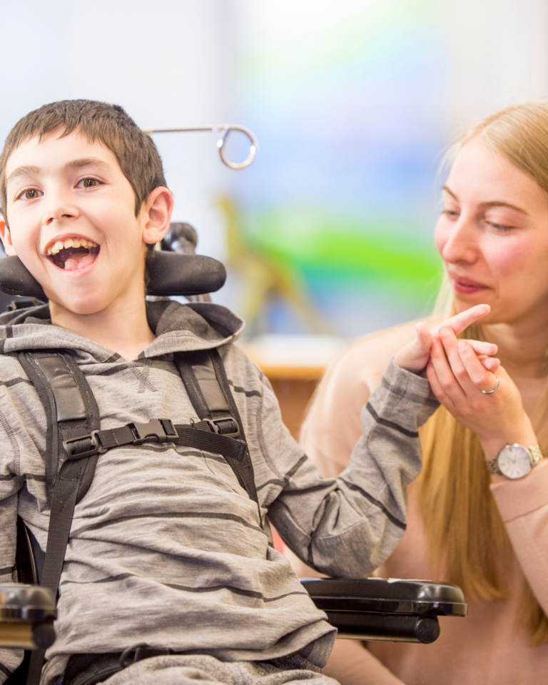 A special needs student in a wheelchair is pictured with an adult, engaging in an activity developed on the prephonics special educational needs courses by the learning lady.